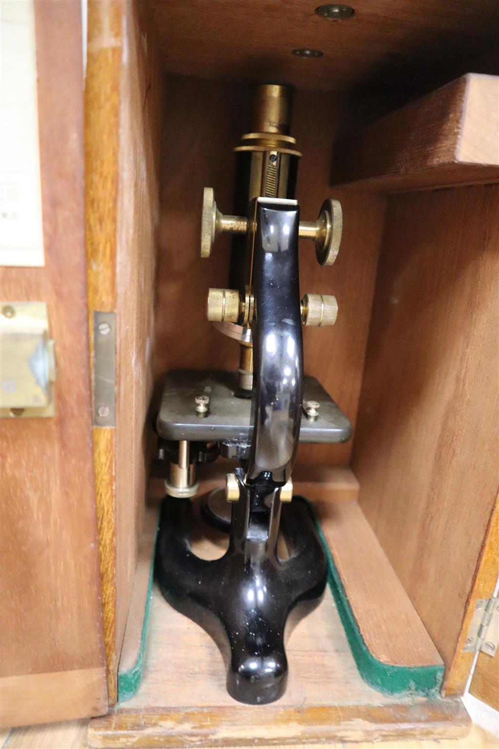Three various cased microscopes
